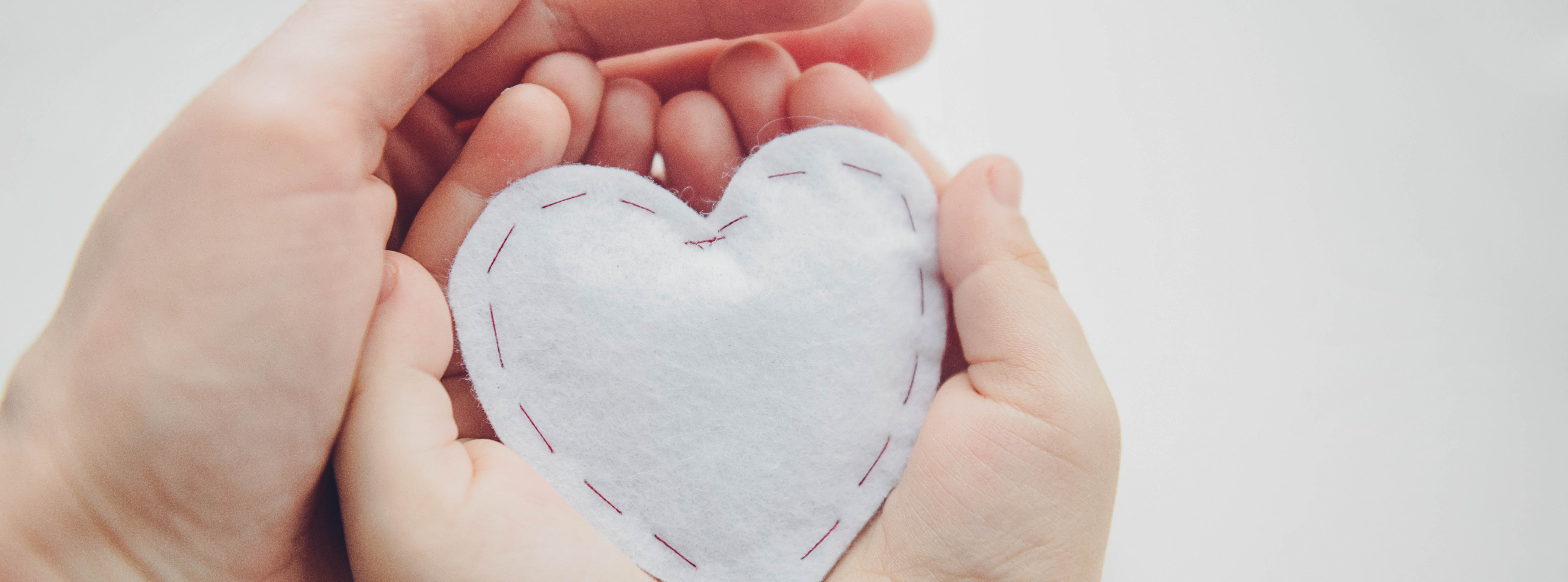 Charitable-Giving_Two-hands-holding-white-heart_660x245